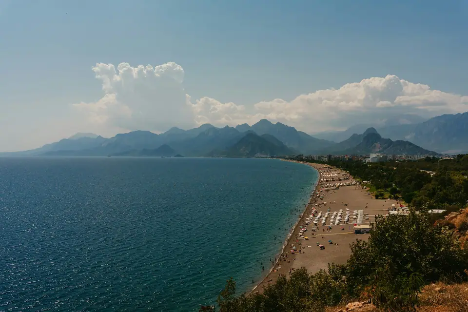 Long pebble beach and mountains in Antalya