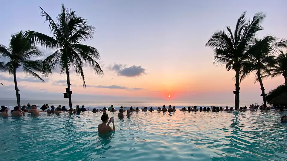 Sunset over the sea from a Bali pool