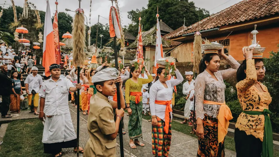 Balinese procession in sarongs and sashes