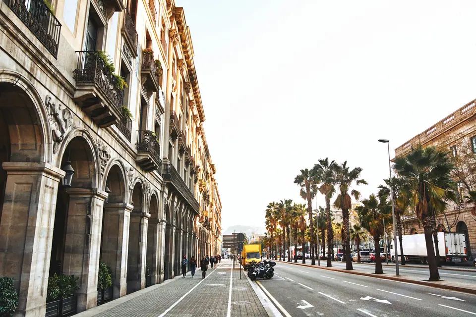 Arcaded street with palms in Barcelona