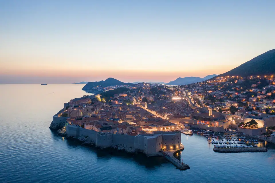 Dubrovnik Old Town lit up at dusk from above