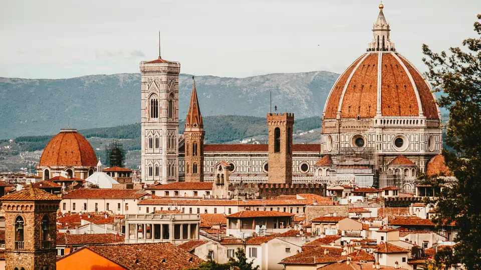 View over the rooftops of Florence with the red-tiled dome of the cathedral and its bell tower in the centre