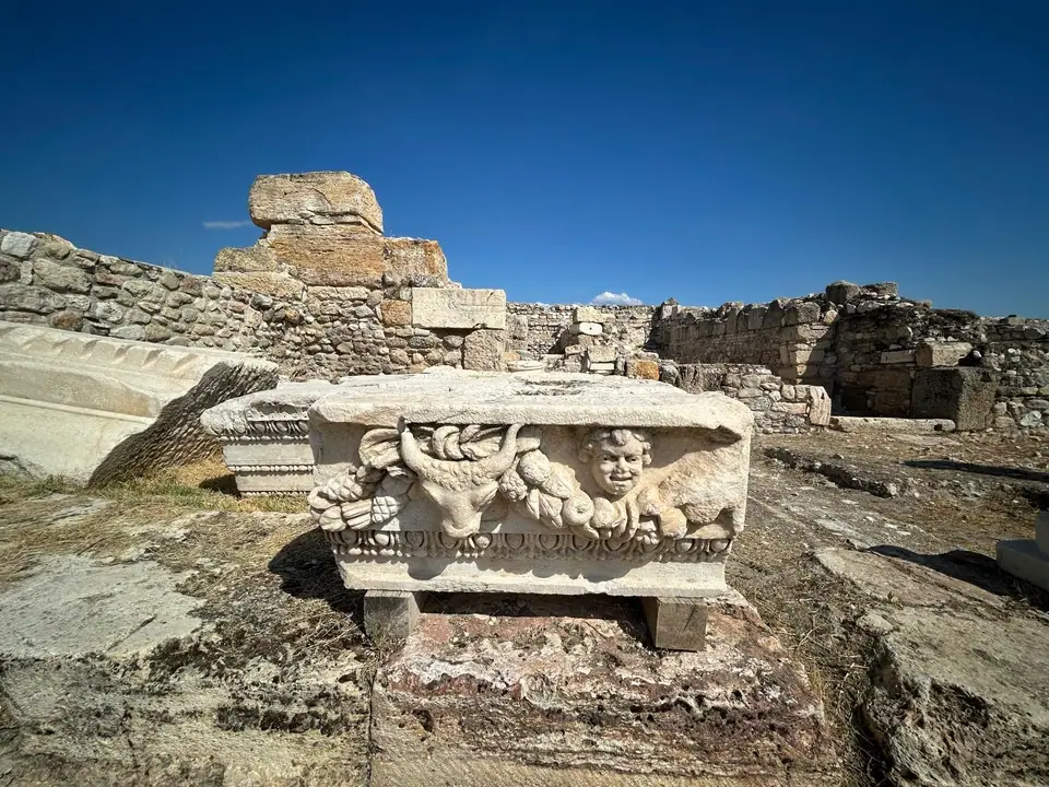 Marble block at Tripolis carved with garlands and a Medusa-like face