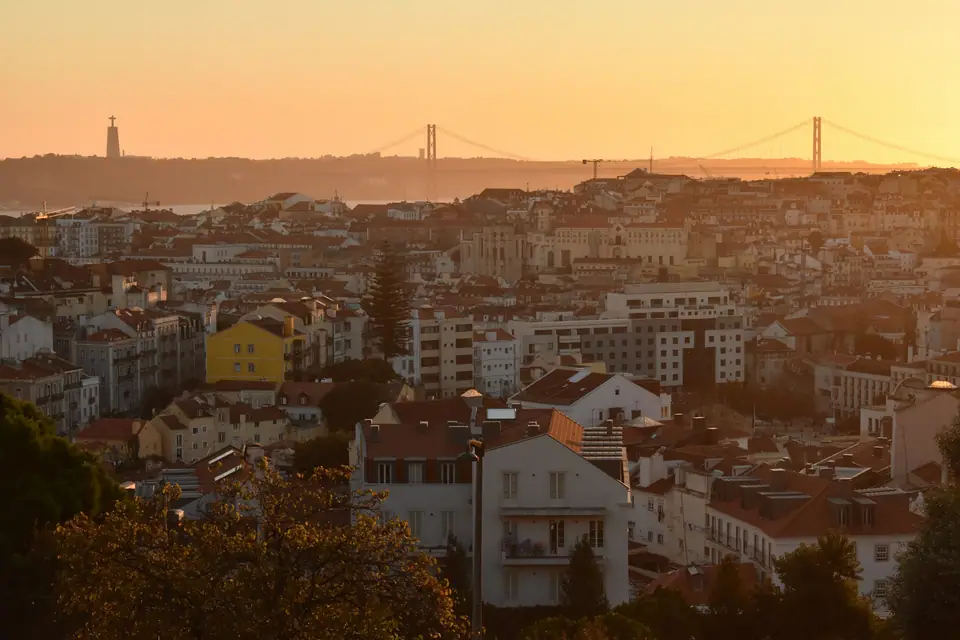 Lisbon rooftops in warm sunset light seen from a viewpoint