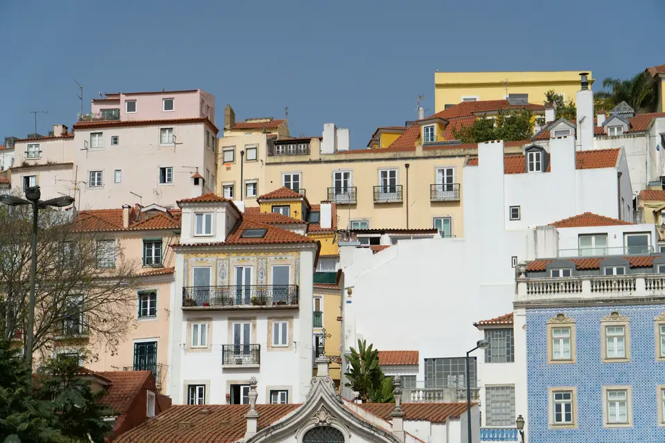 Tightly packed pastel houses on the Alfama hillside in Lisbon