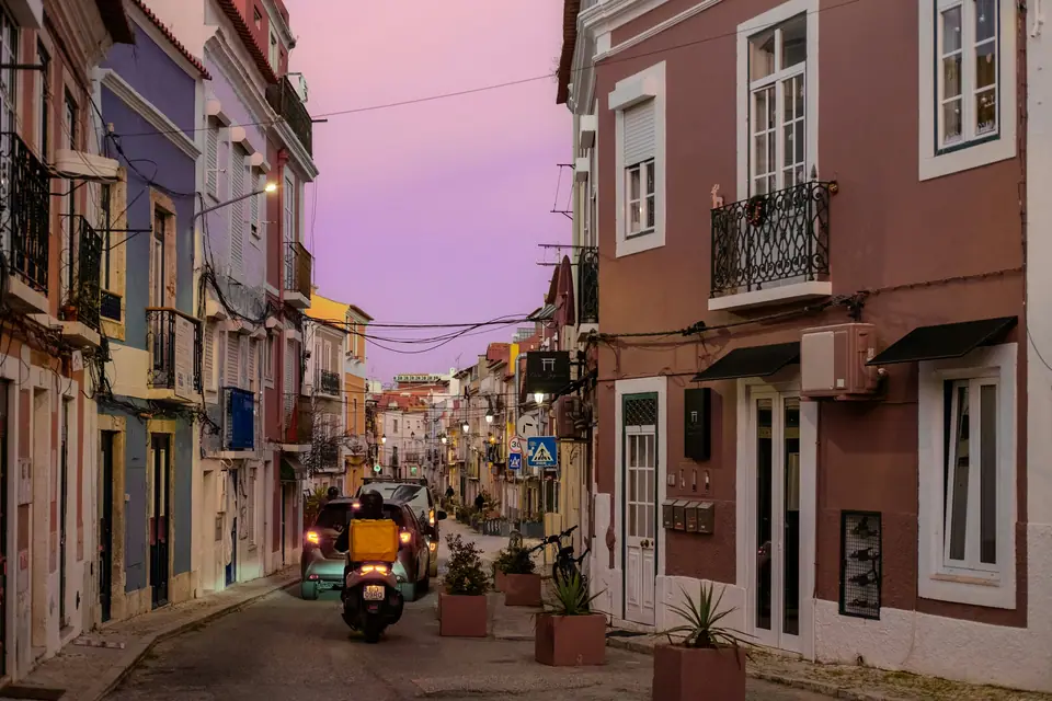 Pink and cream houses on a quiet Lisbon street at dusk