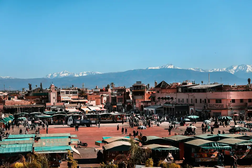 Rooftop terrace over the Marrakech medina with the Atlas Mountains on the horizon