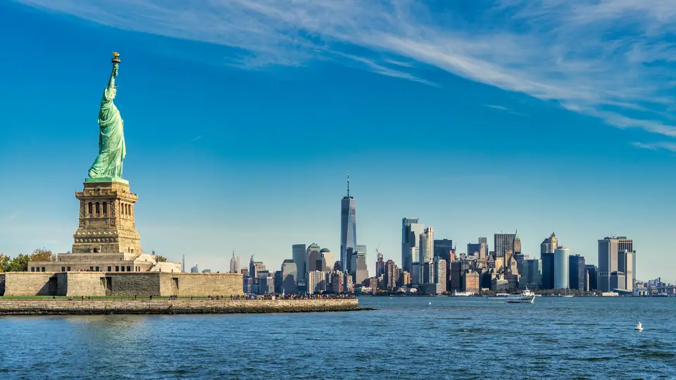 Statue of Liberty in front of the Manhattan skyline