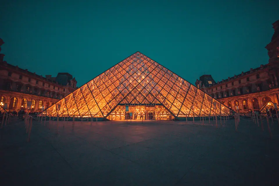 The Louvre pyramid lit up at night