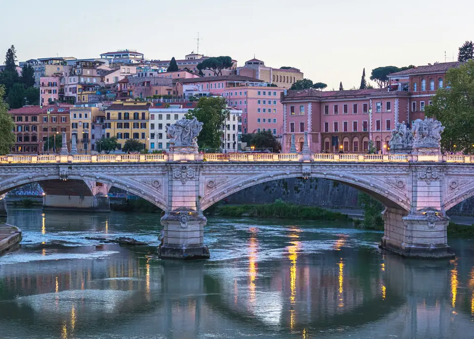 Bridge over the Tiber with pastel buildings in Rome
