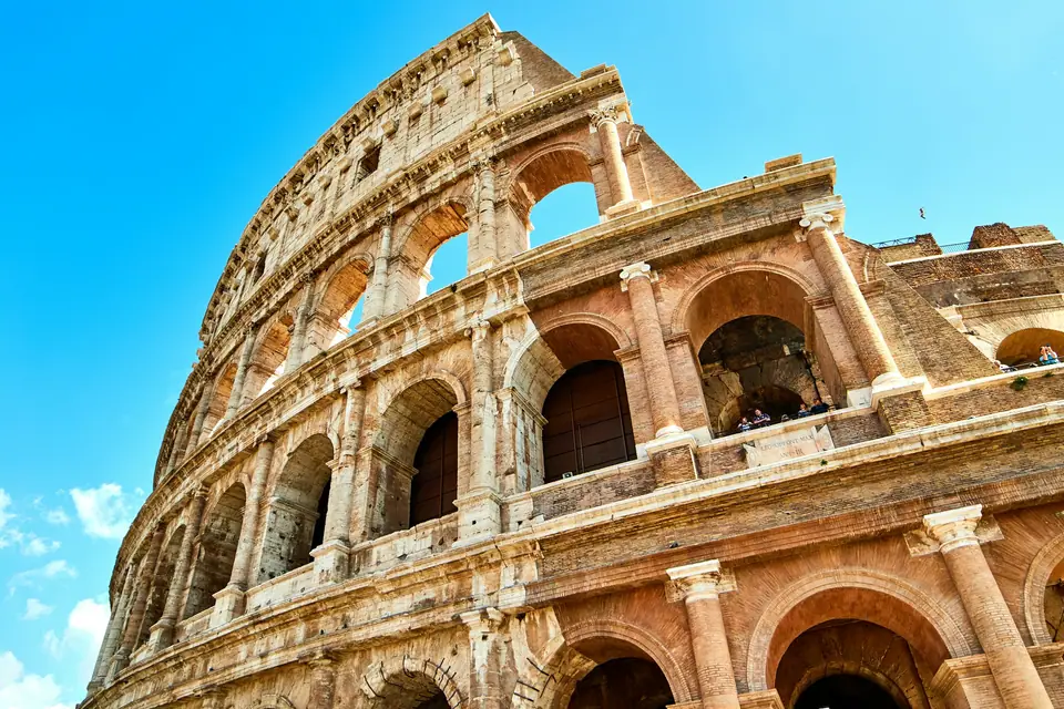 Arches of the Colosseum against a blue sky