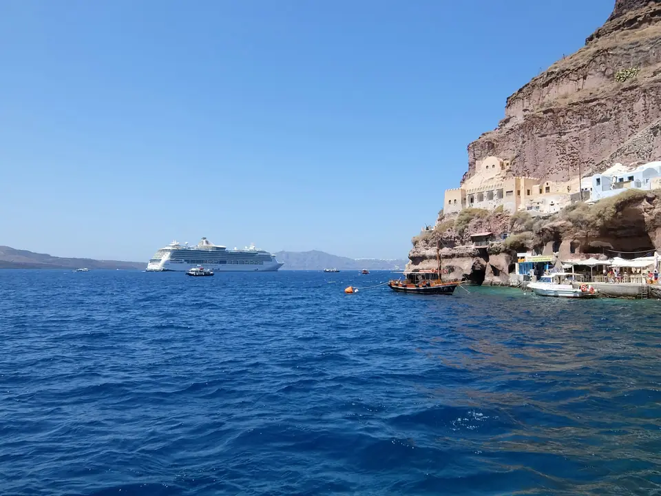 Ship anchored below the Santorini cliffs