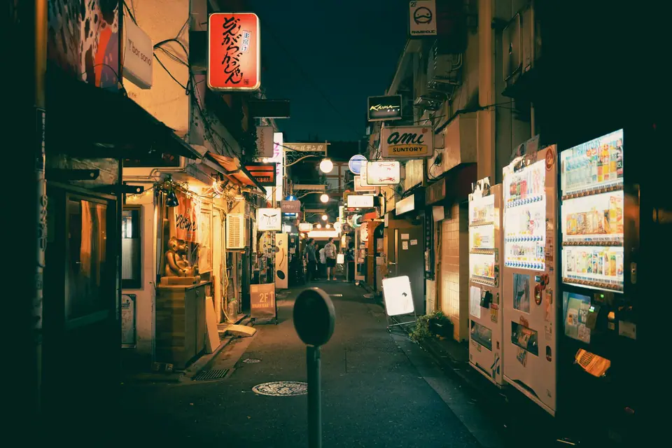 Narrow lantern-lit alley of small bars in Shinjuku at night